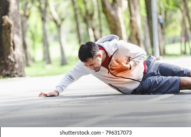 Asian cardiac arrest running young man heart attack in park.Severe heartache,First aid to people with heart disease. - Shutterstock ID 796317073