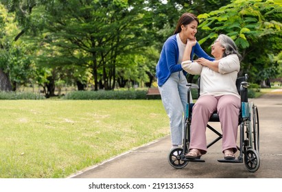 Asian Careful Caregiver Or Nurse Taking Care Of The Patient In A Wheelchair.  Concept Of Happy Retirement With Care From A Caregiver And Savings And Senior Health Insurance, A Happy Family