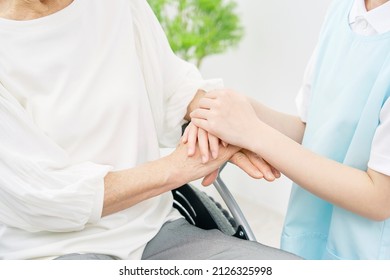 Asian Caregiver And Senior Woman On The Wheelchair, No Face