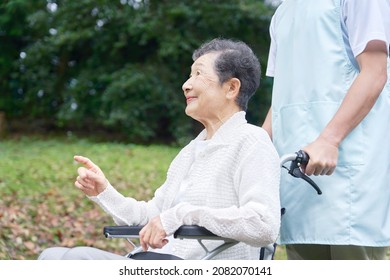 Asian Caregiver And Senior Woman, Out Door