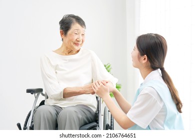 Asian Caregiver And A Senior Woman At The Room