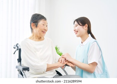 Asian caregiver and senior woman at the room