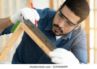 Asian Carpenter Working With Machinist Square To Measure Of Wood In The Wood Workshop