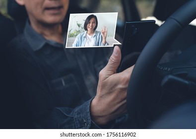 Asian casual man making facetime video calling to his girl friend using  zoom online meeting app via mobile smart phone inside a car during a journey - Shutterstock ID 1756116902