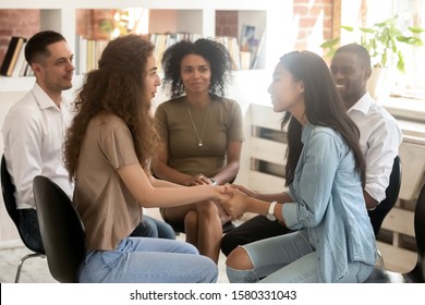 Asian And Caucasian Women Holding Hands At Group Therapy Session, Compassion Empathy Concept, Psychological Support, Diverse Friends Overcome Problem Together, Addiction Treatment Or Team Building