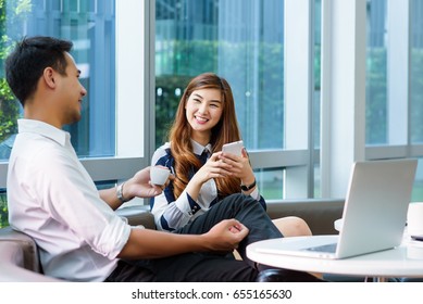 Asian Charming Beautiful Business Woman Talking And Discussing With Her Colleague In Modern Office Or Working Space. Project And Business Concept.