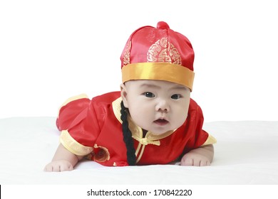 Asian Cheerful Baby Boy Wearing Red Chinese New Year Suit Or Clothes With Hat On White Bed And Background In Studio