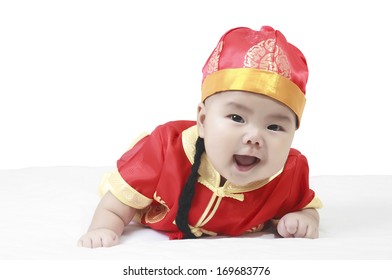 Asian Cheerful And Smile Baby Boy Wearing Red Chinese New Year Suit Or Clothes With Hat On White Bed And Background In Studio Isolated