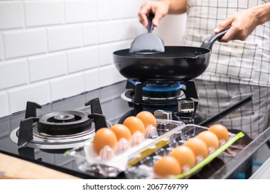 Asian Chef Fried Eggs On Pan To Thai Food In Kitchen On Gas Stove The Oil In Pan Boiling.Eggs And Pork Cooked. Before Serving To Happy Family To Eat Togetherness In Home