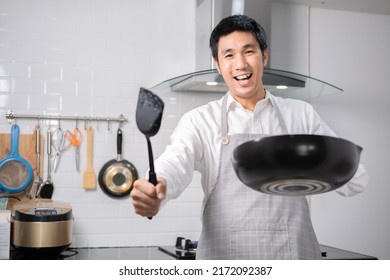 Asian Chef Fried Eggs On Pan To Thai Food In Kitchen On Gas Stove The Oil In Pan Boiling.Eggs And Pork Cooked. Before Serving To Happy Family To Eat Togetherness In Home