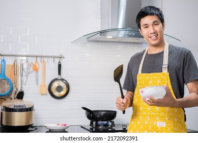 Asian Chef Fried Eggs On Pan To Thai Food In Kitchen On Gas Stove The Oil In Pan Boiling.Eggs And Pork Cooked. Before Serving To Happy Family To Eat Togetherness In Home