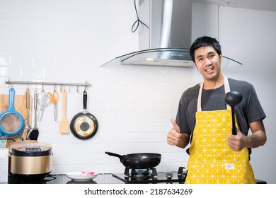 Asian Chef Fried Eggs On Pan To Thai Food In Kitchen On Gas Stove The Oil In Pan Boiling.Eggs And Pork Cooked. Before Serving To Happy Family To Eat Togetherness In Home