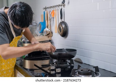 Asian Chef Fried Eggs On Pan To Thai Food In Kitchen On Gas Stove The Oil In Pan Boiling.Eggs And Pork Cooked. Before Serving To Happy Family To Eat Togetherness In Home