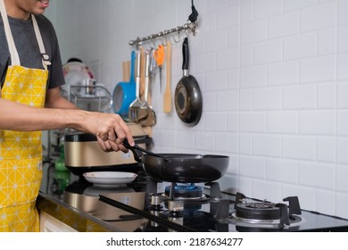 Asian Chef Fried Eggs On Pan To Thai Food In Kitchen On Gas Stove The Oil In Pan Boiling.Eggs And Pork Cooked. Before Serving To Happy Family To Eat Togetherness In Home