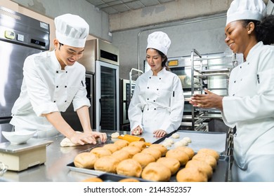 Asian Chefs  baker in a chef dress and hat, cooking together in kitchen.Team of professional cooks in uniform preparing meals for a restaurant in the kitchen. - Powered by Shutterstock