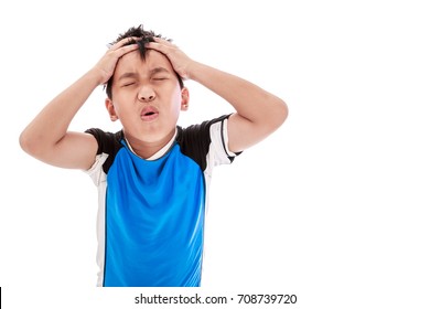 Asian Child Athletes Suffering From  Headache Pain And Pressing Hands To His Head With Copy Space. Human Facial Expression Feeling. Boy With Painful Gesture. Isolated On White Background. Studio Shot.