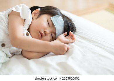 Asian Child In Bed With Fever