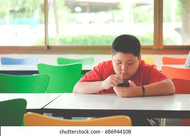 Asian child Boy are addictive playing tablet and mobile phones, Game Addiction