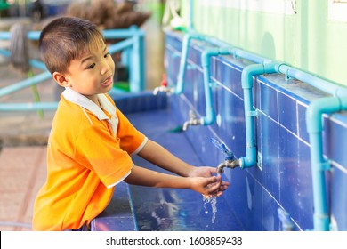 Asian Child Boy Washing His Hands Before Eating Food And After Play The Toys At The Washing Bowl At The School. A Boy Aged Of 5 Years Old. Health Care And Kid Concept. 