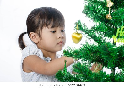 Asian Child And Christmas Tree On White Background