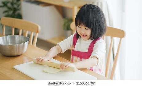 Asian Child Cooking Alone At Home