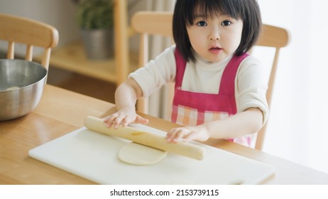 Asian Child Cooking Alone At Home