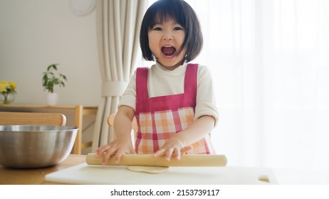 Asian Child Cooking Alone At Home