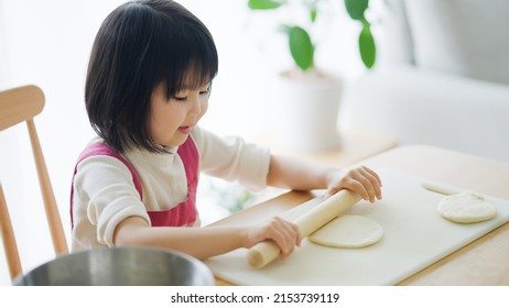 Asian Child Cooking Alone At Home