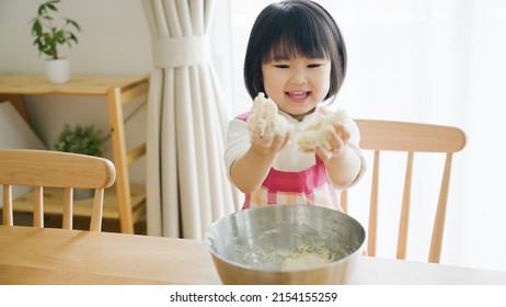 Asian Child Cooking Alone At Home