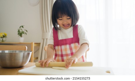 Asian Child Cooking Alone At Home