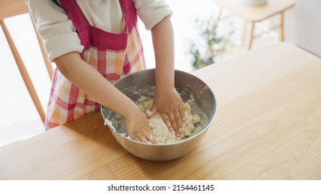 Asian Child Cooking Alone At Home