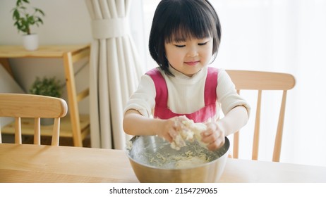 Asian Child Cooking Alone At Home