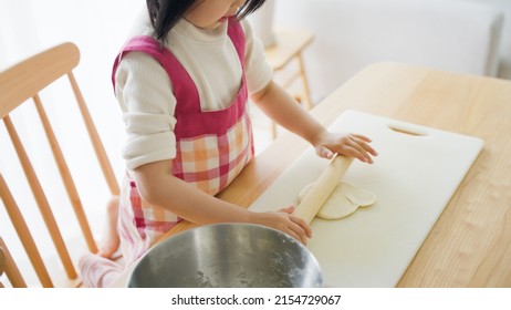 Asian Child Cooking Alone At Home