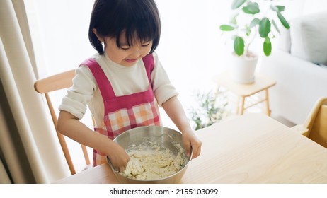 Asian Child Cooking Alone At Home