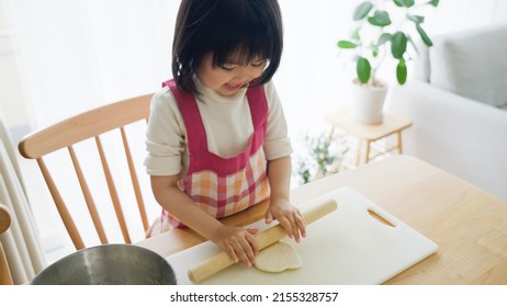 Asian Child Cooking Alone At Home