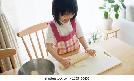 Asian Child Cooking Alone At Home