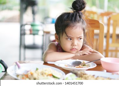 Asian Child Cute Or Kid Girl Anorexia Or Sad And Bored Food Or Boredom With Sleepy Vacant And Prop Up Or Hand To Cheek On Wood Table For Breakfast Or Lunch Eating At Restaurant On Preschool