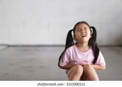 Asian Child Cute Or Kid Girl Sit Stomachache And Sick From Bacteria And Gastritis With Diarrhea Or Hungry With Holding Hand In Stomach To Frown And Poor On Street With Space