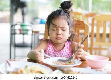 Asian Child Cute Or Kid Girl Anorexia Or Sad And Bored Food Or Boredom With Frown On Wood Table For Breakfast Or Lunch Eating At Restaurant On Preschool Or Nursery