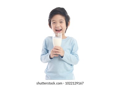 Asian Child Drinking Milk From A Glass On White Background Isolated