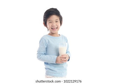 Asian Child Drinking Milk From A Glass On White Background Isolated