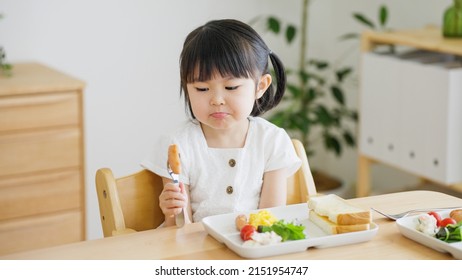 Asian child eating in the living room - Powered by Shutterstock