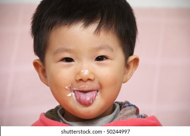 Asian Child Eating Yogurt