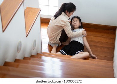 Asian Child Girl In Coma On Floor Feeling Unconscious After Accident,falling Down From Staircase,sick Daughter Fell Or Slipped To Floor Because Of Dizziness,faint,mother To Help,care,support Of Her