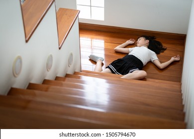 Asian Child Girl In Coma On Floor Felling Unconscious After Accident,falling Down From Staircase,sick Female Fell Or Slipped To The Floor Because Of Dizziness,faint,suffering From Illness At Home