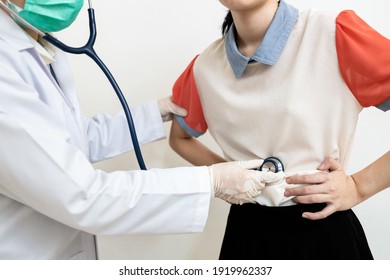 Asian Child Girl With Flatulence,bloated Stomach Checking The Abdomen,physical Examination,doctor Using A Stethoscope,listen To The Sound Of Bowel Movement,indigestion,pain Illness,abdominal Problems