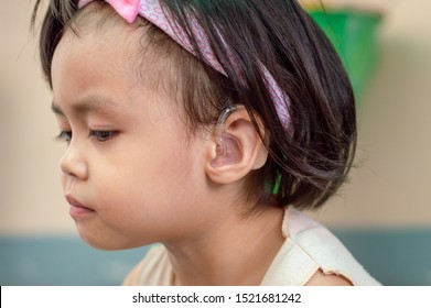 Asian Child Girl Hearing Impaired Wear Hearing Aids.