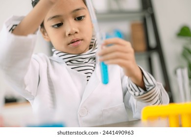 Asian child girl learning science chemistry with test tube making experiment at school laboratory. education, science, chemistry, and children's concepts. Early development of children. - Powered by Shutterstock