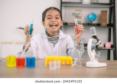 Asian child girl learning science chemistry with test tube making experiment at school laboratory. education, science, chemistry, and children's concepts. Early development of children. - Powered by Shutterstock