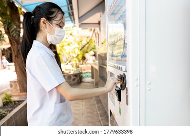 Asian Child Girl In Medical Mask,social Distancing,keep Distance By Buying Food,snacks Beverage Or Drinking Water From Vending Machine Instead Of Going To The Convenience Store To Reduce Congestion